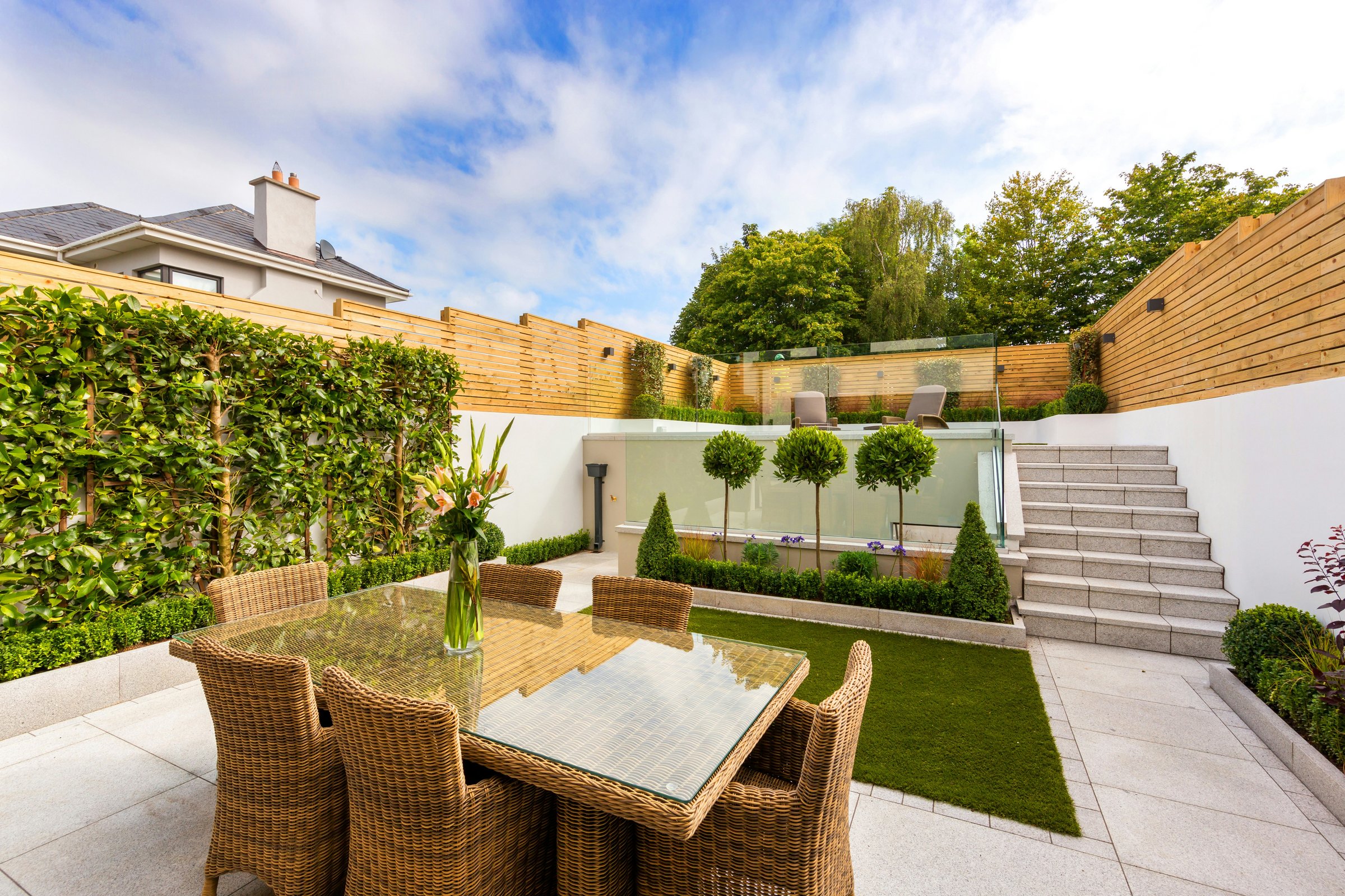 Premium porcelain patio, timber fencing, stone steps and manicured lawn — Red Deer Gardens, Berkshire